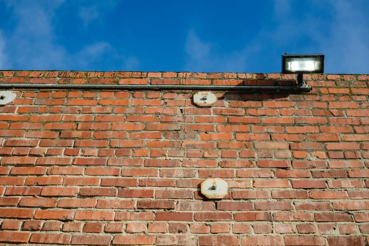 Staggered home outside security lights creating layered nighttime defense