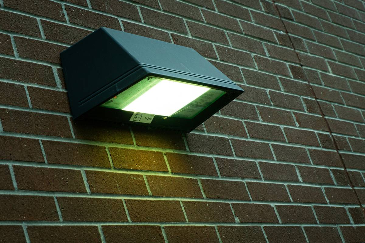 Step-by-step installation of fitting wall mounted outside security lights showing correct height and angle